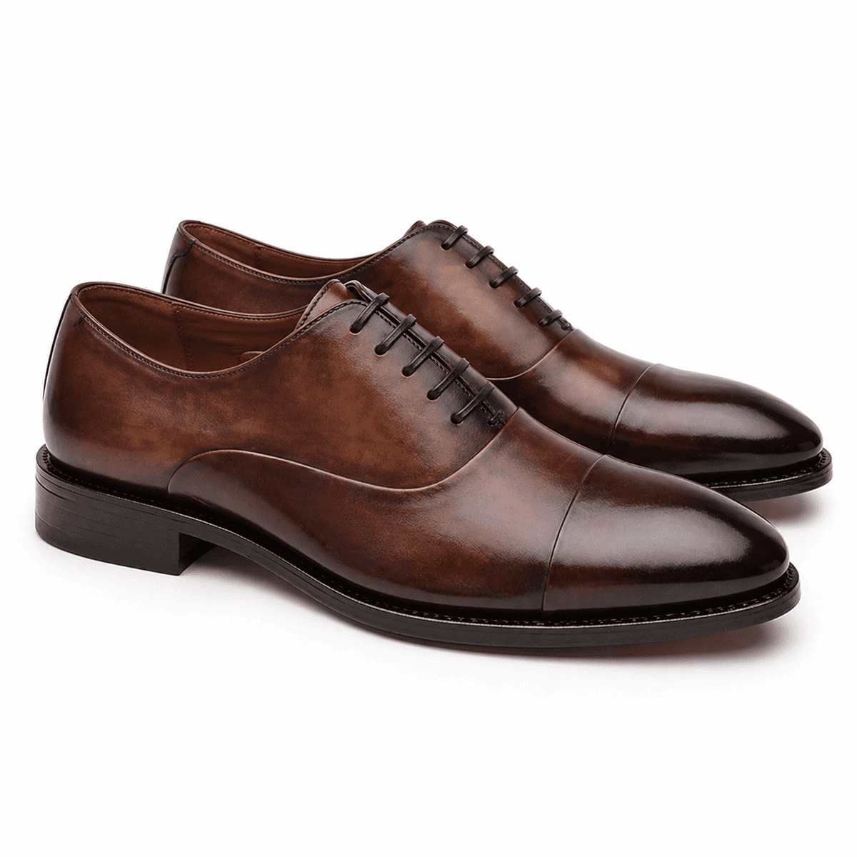 Pair of brown leather Oxford shoes with cap toe design and lace-up closure for men formal wear