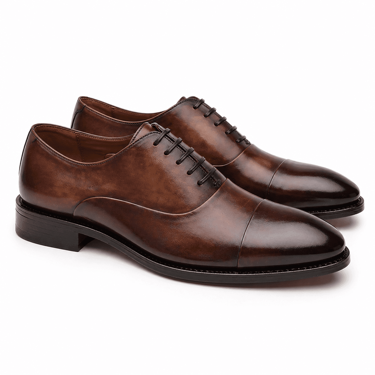 Pair of brown leather Oxford shoes with cap toe design and lace-up closure for men formal wear
