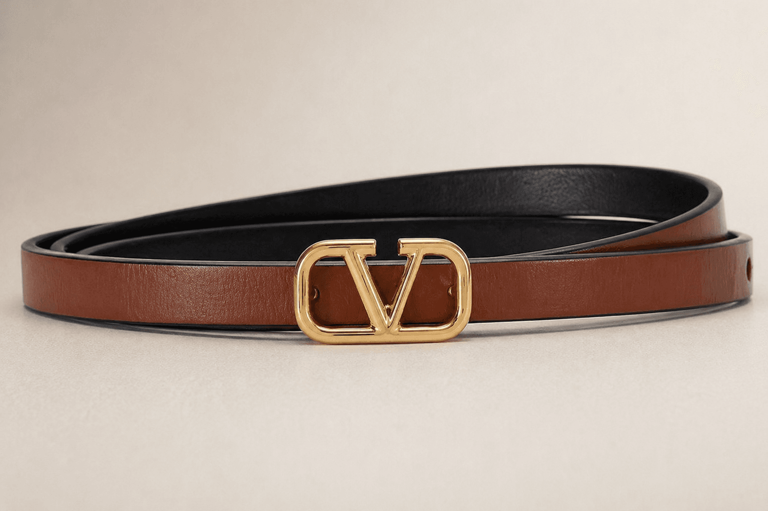 Slim brown leather belt with gold V buckle worn on waist outfit styling